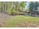 Expansive backyard showcasing lush greenery, mature trees, and a gentle slope at 24 Laurel Ne Way, White, GA 30184