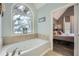Relaxing soaking tub with large window adjacent to spacious and bright bedroom at 24 Laurel Ne Way, White, GA 30184