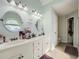 Bright bathroom featuring double sink vanity, modern fixtures, and adjacent bedroom view at 24 Laurel Ne Way, White, GA 30184