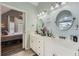 Dual sink bathroom vanity with large mirrors and view to an adjacent bedroom space at 24 Laurel Ne Way, White, GA 30184