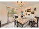 Cozy dining area with a chandelier, rustic table setting, and natural light at 24 Laurel Ne Way, White, GA 30184