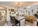 Open-concept dining area leading to living room, skylight for natural light and modern chandelier at 24 Laurel Ne Way, White, GA 30184