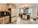 Bright kitchen with modern island, stainless steel refrigerator, and stylish wood-look flooring at 24 Laurel Ne Way, White, GA 30184