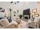 Cozy living room featuring a stone fireplace, skylights, and stylish decor elements at 24 Laurel Ne Way, White, GA 30184