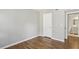 Bedroom features hardwood floors, neutral paint, closet, and door to ensuite at 3091 Colonial Way # F2, Atlanta, GA 30341