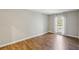 Bedroom features hardwood floors, neutral paint, and sunny windows at 3091 Colonial Way # F2, Atlanta, GA 30341