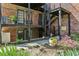 Charming brick building with iron balconies and lush landscaping creating an inviting outdoor space at 3091 Colonial Way # F2, Atlanta, GA 30341