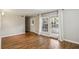 An empty living room featuring hardwood floors and light gray paint and a view of an exterior patio at 3091 Colonial Way # F2, Atlanta, GA 30341