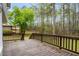 Spacious wooden back deck overlooking lush greenery and trees at 7275 Oswego Trl, Riverdale, GA 30296
