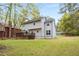 Two-story home featuring a backyard with a large deck and lush green lawn at 7275 Oswego Trl, Riverdale, GA 30296