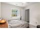 Bedroom featuring a window, light walls, and a comfortable bed at 7275 Oswego Trl, Riverdale, GA 30296