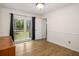 Bedroom with wood floor and a scenic backyard view through a large window at 7275 Oswego Trl, Riverdale, GA 30296