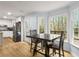 Dining area with large windows overlooking the backyard, with hardwood floors and updated kitchen at 7275 Oswego Trl, Riverdale, GA 30296