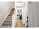 Inviting entryway with staircase, hardwood floors, and open view into the modern kitchen at 7275 Oswego Trl, Riverdale, GA 30296