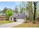 Beautifully landscaped single-Gathering home with attached garage and a well-manicured front yard at 7275 Oswego Trl, Riverdale, GA 30296