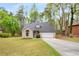 Charming single-Gathering home with well-manicured front yard, long driveway, and attached garage at 7275 Oswego Trl, Riverdale, GA 30296