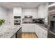 Bright kitchen featuring white cabinets, stainless steel appliances, and granite countertops at 7275 Oswego Trl, Riverdale, GA 30296