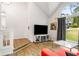 Bright living room with a vaulted ceiling, large windows, and modern furnishings at 7275 Oswego Trl, Riverdale, GA 30296