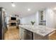 Open concept kitchen and living room with a brick fireplace and stainless steel appliances at 7275 Oswego Trl, Riverdale, GA 30296