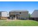 A green backyard features a deck, screened-in patio and a well-maintained lawn at 225 Mary Jane Ln, Covington, GA 30016