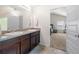 Bathroom featuring double sinks with granite counters and access to the bedroom at 225 Mary Jane Ln, Covington, GA 30016