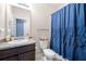 Bathroom featuring a dark wood vanity, toilet, and blue shower curtain at 225 Mary Jane Ln, Covington, GA 30016