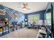 Bright bedroom featuring a fun wall design and an array of toys and entertainment at 225 Mary Jane Ln, Covington, GA 30016