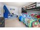 A playful ' bedroom with a bunk bed, fun decor, and ample toy storage at 225 Mary Jane Ln, Covington, GA 30016