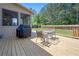 Wooden deck with a grill and patio table for enjoying outdoor dining at 225 Mary Jane Ln, Covington, GA 30016