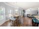 Dining area with wood floors, large window, and an adjacent living space at 225 Mary Jane Ln, Covington, GA 30016