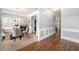 Elegant dining room featuring hardwood floors, wainscoting, and a modern chandelier at 225 Mary Jane Ln, Covington, GA 30016