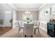 Formal dining room featuring crown molding, chandelier, and a large window at 225 Mary Jane Ln, Covington, GA 30016