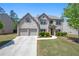 Charming two-story brick home with well-manicured lawn and attached two-car garage at 225 Mary Jane Ln, Covington, GA 30016