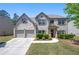 Charming two-story brick home with well-manicured lawn and attached two-car garage at 225 Mary Jane Ln, Covington, GA 30016