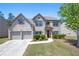 Charming two-story brick home with well-manicured lawn and attached two-car garage at 225 Mary Jane Ln, Covington, GA 30016
