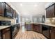 Well-equipped kitchen with stainless steel appliances, granite countertops, and dark wood cabinets at 225 Mary Jane Ln, Covington, GA 30016