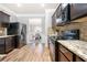 Well-equipped kitchen with stainless steel appliances, granite countertops, and dark wood cabinets at 225 Mary Jane Ln, Covington, GA 30016