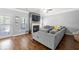 Well-lit living room with gray sectional sofa and fireplace at 225 Mary Jane Ln, Covington, GA 30016