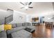 Open-concept living room with a grey sectional, a staircase, and a view of the kitchen at 225 Mary Jane Ln, Covington, GA 30016