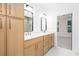 Bright bathroom features double sinks, wood cabinets, and a door to the Primary bedroom at 2286 Carver Nw Dr, Atlanta, GA 30314