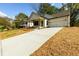 This is a nice view of the exterior of this house with a long concrete driveway at 2286 Carver Nw Dr, Atlanta, GA 30314