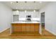 Bright kitchen features an island with wood cabinets, white countertops and modern pendant lighting at 2286 Carver Nw Dr, Atlanta, GA 30314