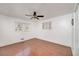 Bright bedroom with wood flooring, white walls, ceiling fan, and a window providing natural light at 313 Fayette Villa Ct, Fayetteville, GA 30214