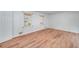 Well-lit bedroom with wood flooring, white walls, and two windows, offering a serene and inviting space at 313 Fayette Villa Ct, Fayetteville, GA 30214
