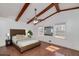 This bedroom features vaulted ceilings with exposed beams and hardwood floors at 313 Fayette Villa Ct, Fayetteville, GA 30214