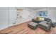 Well-lit staged living room with wood flooring, white walls, and cozy furniture, offering a serene space at 313 Fayette Villa Ct, Fayetteville, GA 30214