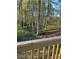 View from the back deck of a lush and leafy backyard with beautiful forest setting at 5851 Swan Walk, Sugar Hill, GA 30518