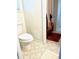 Neutral bathroom featuring patterned floors, toilet, shower with curtain, and door to hallway at 5851 Swan Walk, Sugar Hill, GA 30518