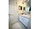 Bathroom featuring white cabinets, framed art, and tiled floors at 5851 Swan Walk, Sugar Hill, GA 30518