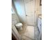 Small bathroom featuring white toilet and tiled floors at 5851 Swan Walk, Sugar Hill, GA 30518